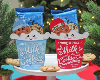 May include: Two festive cookie and milk gift sets. One is blue with "Chip Chip Hooray!" text, the other is red with "North Pole Milk and Cookie Co." text. Each set includes cookies and a cute cookie character.