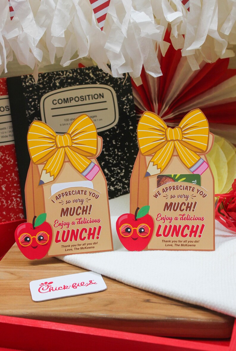 May include: Two brown paper lunch bags with yellow bows and red apple illustrations. The bags have a message that says "I appreciate you so very much! Enjoy a delicious lunch! Thank you for all you do! Love, The McKowns."  A Chick-fil-A logo is visible in the bottom left corner.