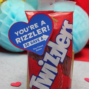 May include: A red bag of Twizzlers candy twists with a blue heart-shaped sticker that says "You're a rizzler! So have a..." and "Your Friend, Easton".
