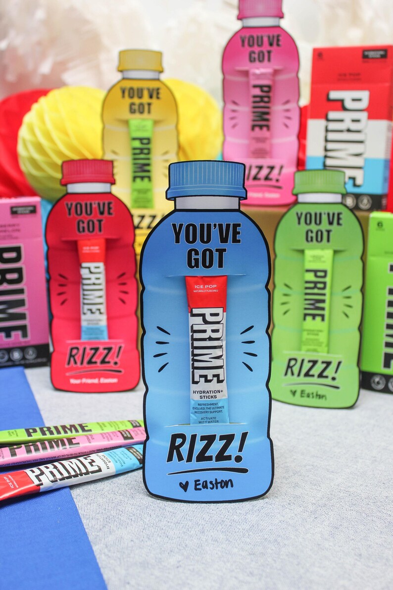 May include: A blue and white cardboard cutout of a sports drink bottle with the text "You've Got Prime Rizz! Easton" and a Prime Hydration stick inside. The cutout is surrounded by other Prime Hydration bottles in various colours.