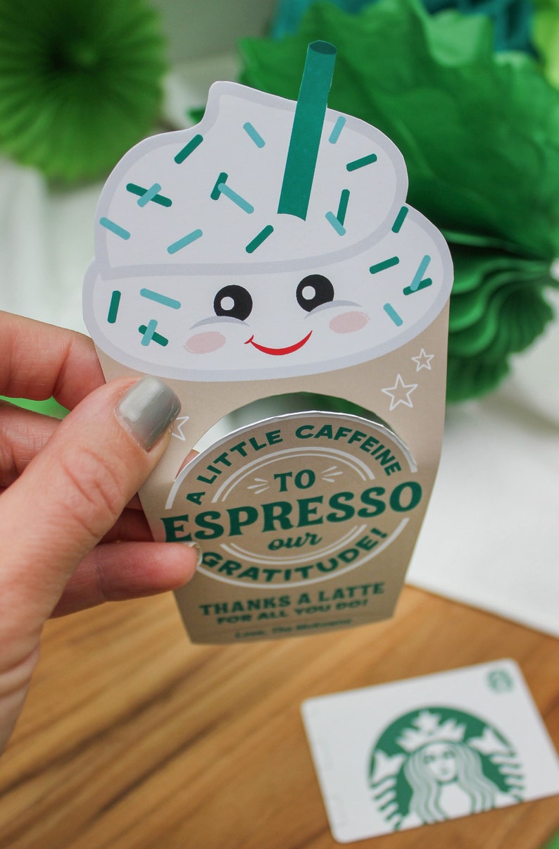 May include: A white and green coffee cup with a smiling face and sprinkles on top. The cup has a silver rim and says "A little caffeine to espresso our gratitude! Thanks a latte for all you do!"