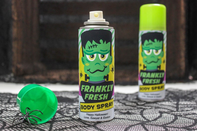 May include: Two green and yellow spray bottles with a Frankenstein monster graphic and the text "Frankly Fresh Body Spray". The text "Happy Halloween! Love, Sawyer & Easton" is printed on the bottom of the bottle.