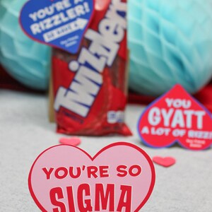 May include: A pink heart-shaped card with the text "You're so Sigma" in red letters. The card has the text "Your Friend, Easton" at the bottom.