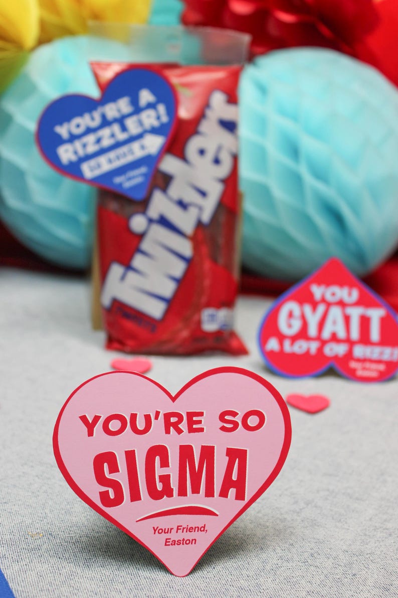 May include: A pink heart-shaped card with the text "You're so Sigma" in red letters. The card has the text "Your Friend, Easton" at the bottom.