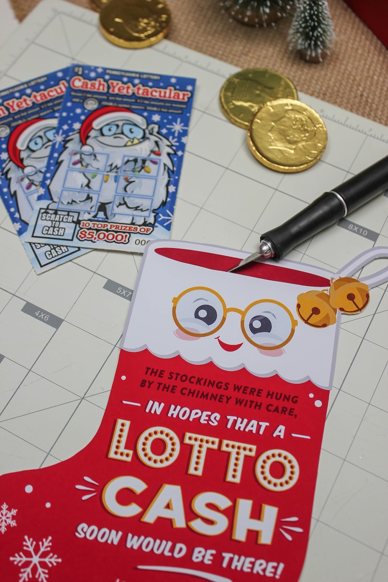 Pode incluir: Uma meia vermelha com um rosto branco, usando &oacute;culos e dois sinos dourados. A meia tem o texto "The stockings were hung by the chimney with care, in hopes that a Lotto Cash soon would be there!"
