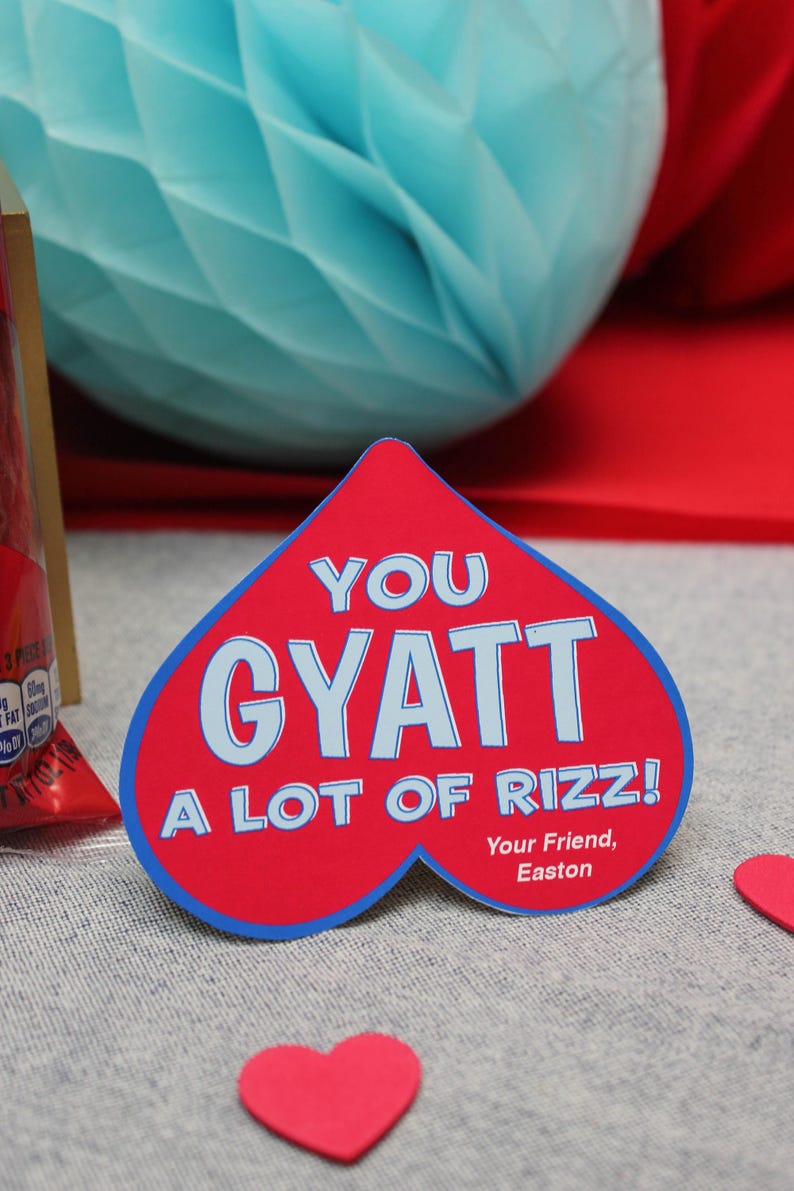May include: A red heart-shaped card with blue trim reads "You Gyatt A Lot Of Rizz!" with the text "Your Friend, Easton" at the bottom.