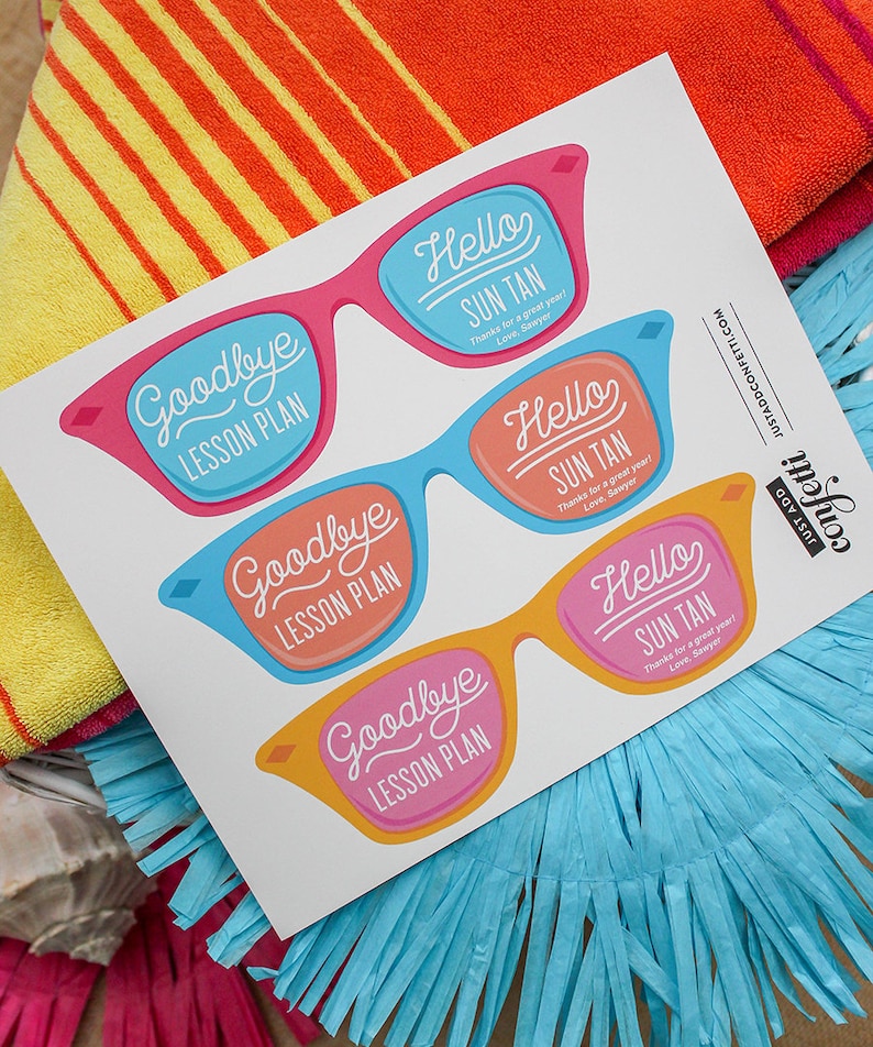 May include: Four colorful sunglasses with the text "Goodbye Lesson Plan" and "Hello Sun Tan" on them. The sunglasses are on a white background with a blue and yellow striped towel behind them.