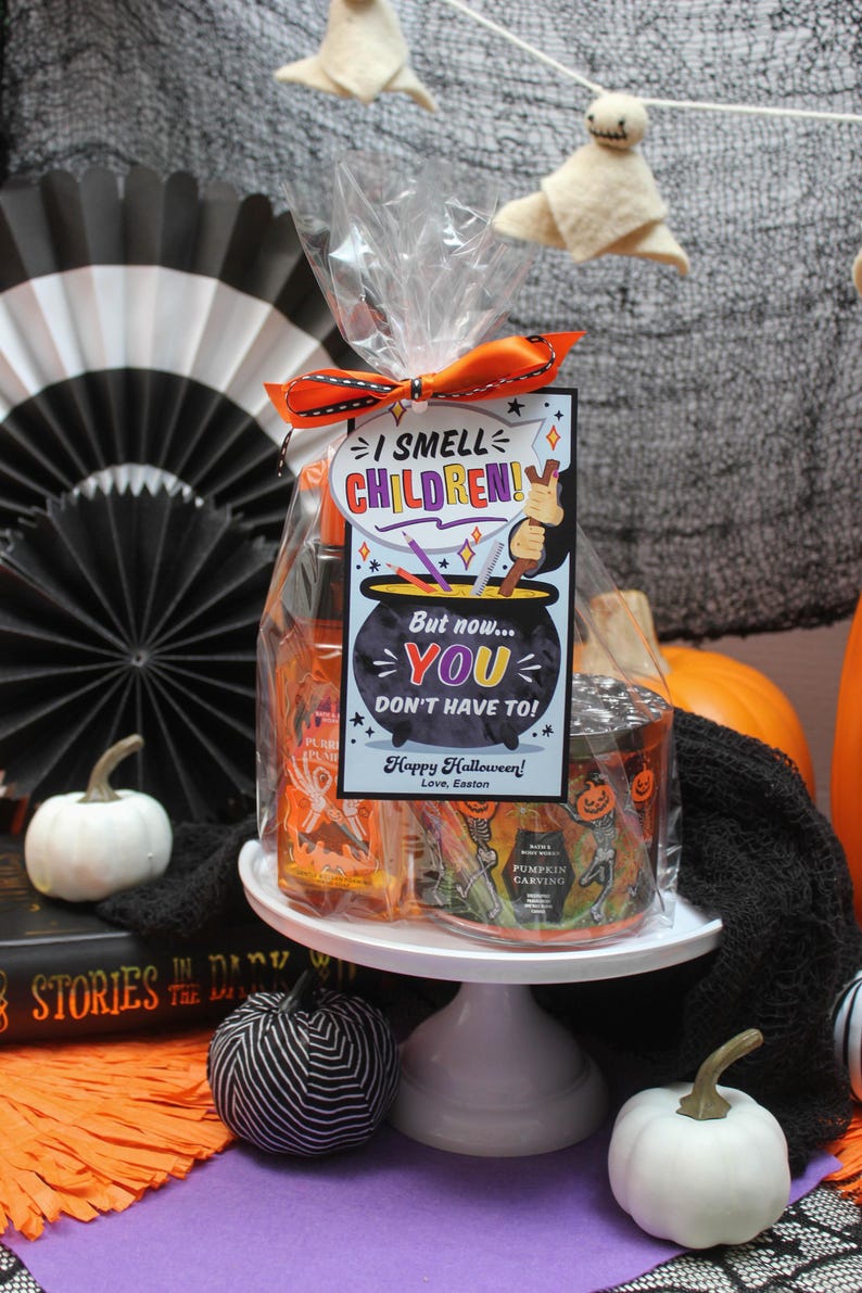 May include: A Halloween gift basket with a cauldron-shaped tag that reads "I smell children! But now... you don't have to!" The basket includes a pumpkin-scented candle and a bottle of hand sanitizer.