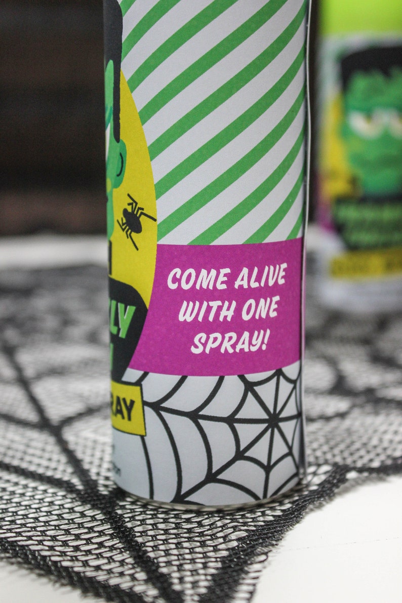 May include: A green and white striped can with a pink label that says "Come alive with one spray!" The can has a spider on it and a black and white spiderweb design.