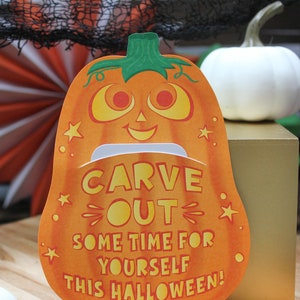 May include: Orange pumpkin-shaped card with a smiling face and the text "CARVE OUT SOME TIME FOR YOURSELF THIS HALLOWEEN!"  Love, The McKowns.