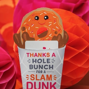 May include: A white paper cup with a donut on top. The cup has a message that says "Thanks a hole bunch for a slam dunk school year! Love, Sawyer".