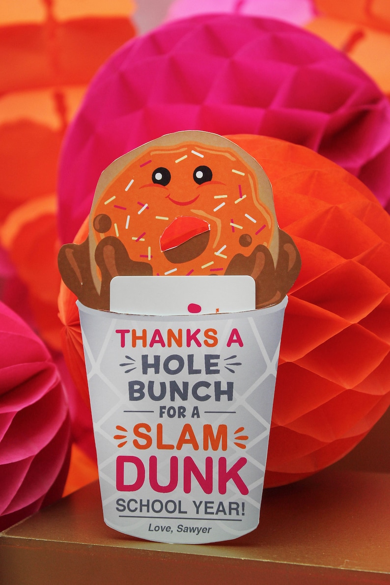 May include: A white paper cup with a donut on top. The cup has a message that says "Thanks a hole bunch for a slam dunk school year! Love, Sawyer".