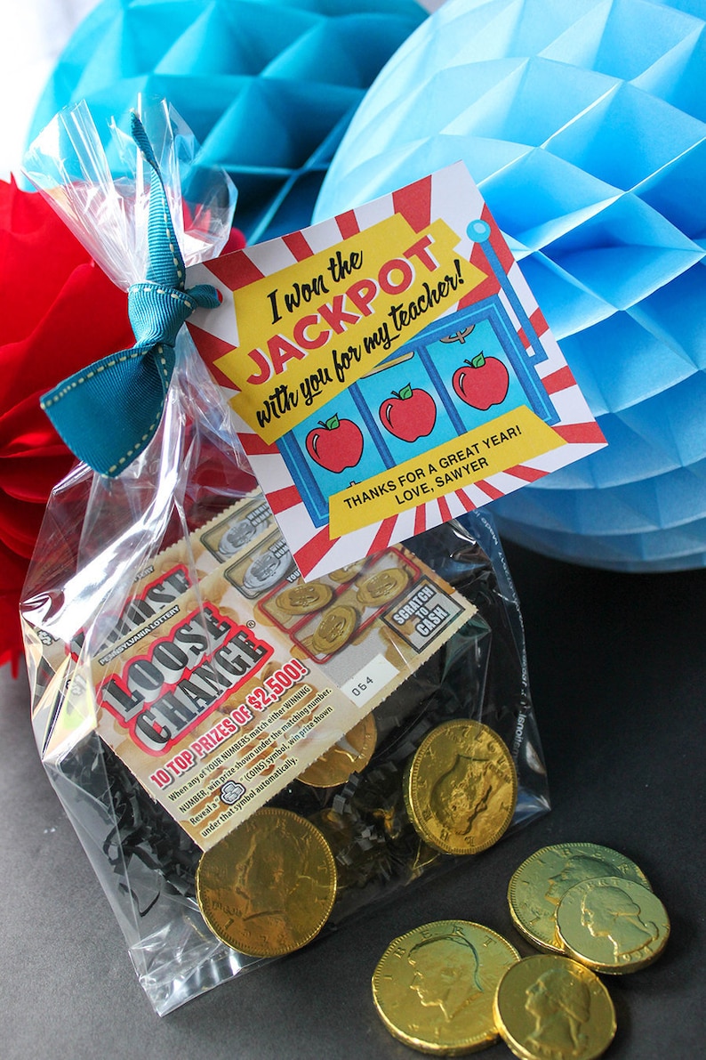 May include: A clear plastic bag filled with gold chocolate coins and lottery tickets. The bag is tied with a blue ribbon and a red and white card that says "I won the JACKPOT with you for my teacher!" and "Thanks for a great year! Love, Sawyer."