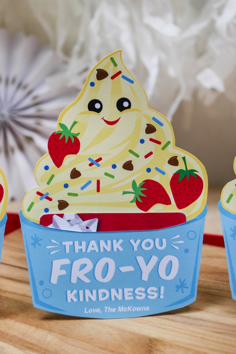 May include: A blue and white thank you card shaped like a frozen yogurt cup with a smiling cartoon face, two strawberries, and chocolate chips. The card says "Thank You Fro-Yo Kindness! Love, The McKowns".