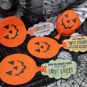 May include: Four orange Halloween trick or treat bags with jack-o-lantern faces. The bags have attached tags with Halloween-themed messages, including "Whooppee! It's Halloween!" and "No Treats Only Tricks! Silly Pranks Have Begun... Time For Some Halloween Fun!"