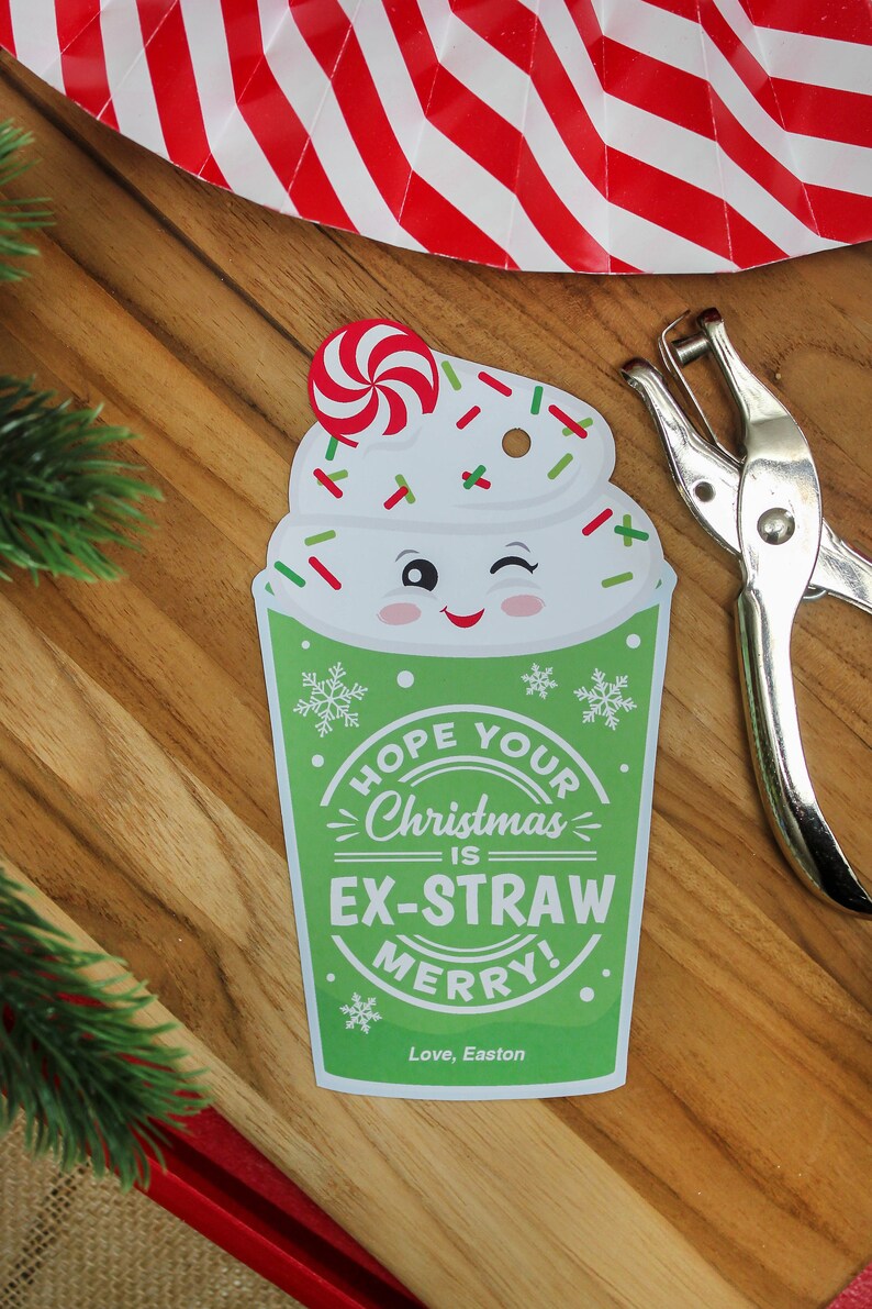 May include: A green and white Christmas gift tag with a cartoon image of a whipped cream drink with a candy cane on top. The tag says "Hope your Christmas is Ex-Straw Merry!" and "Love, Easton".