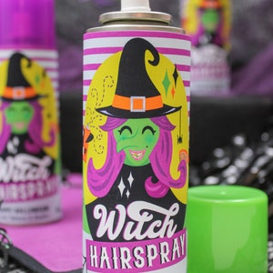 May include: A purple and yellow can of witch hairspray with a cartoon witch on the label. The label says "Witch Hairspray" and "Happy Halloween! Love, Sawyer & Easton".