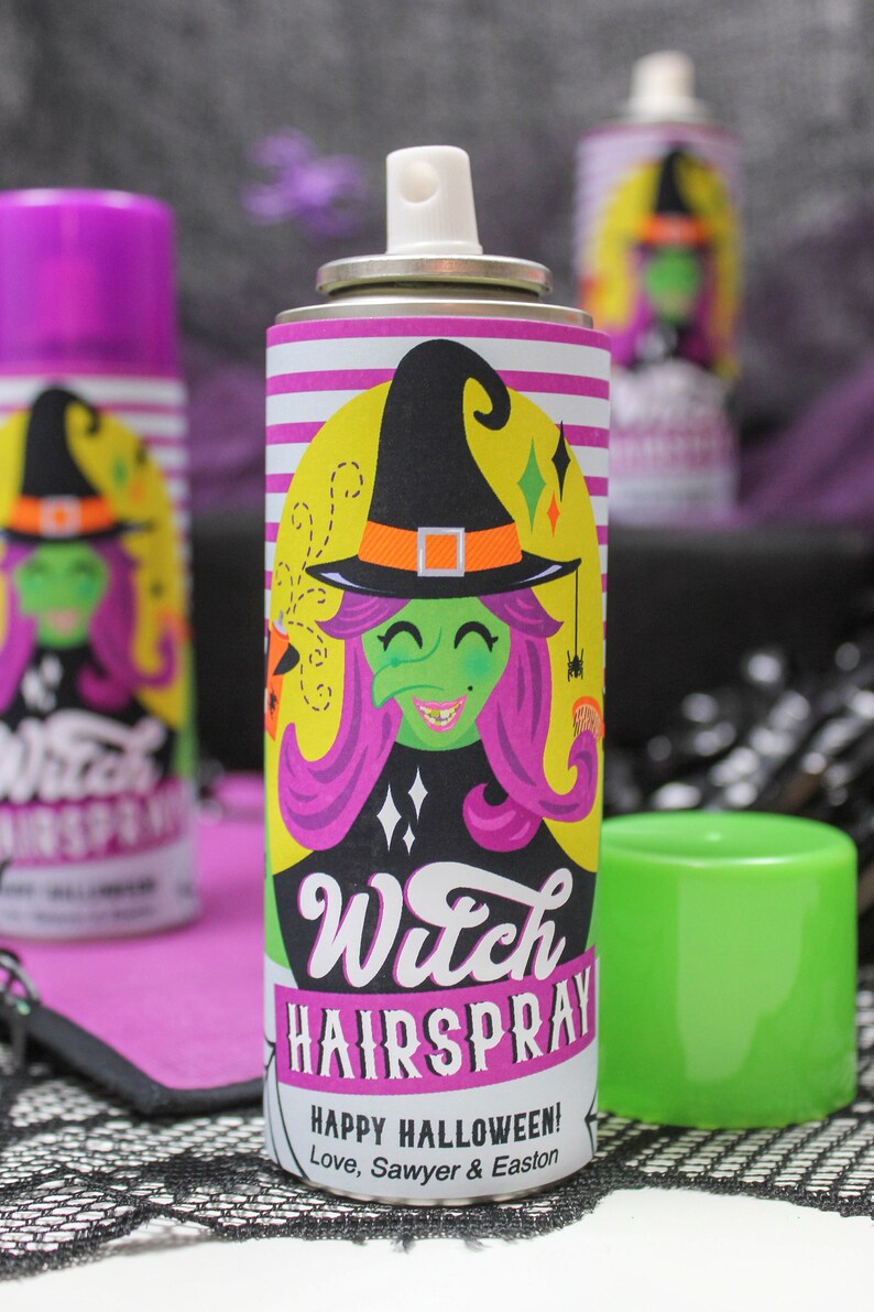 May include: A purple and yellow can of witch hairspray with a cartoon witch on the label. The label says "Witch Hairspray" and "Happy Halloween! Love, Sawyer & Easton".