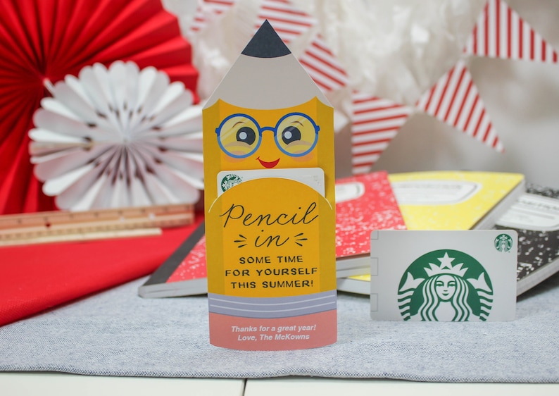May include: A yellow pencil-shaped gift card holder with a smiling face and glasses, holding a Starbucks gift card. The text on the holder reads "Pencil in some time for yourself this summer!" and "Thanks for a great year! Love, The McKowns."