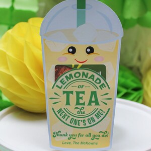 May include: A yellow and green illustrated card with a cartoon lemonade cup with a straw. The card says "Lemonade or Tea - The Next One's On Me!" and "Thank you for all you do! Love, The McKowns".