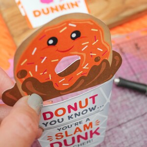 May include: A donut-shaped card with a smiling face and sprinkles. The card is in a paper cup with the text "Donut you know... you're a slam dunk teacher!"