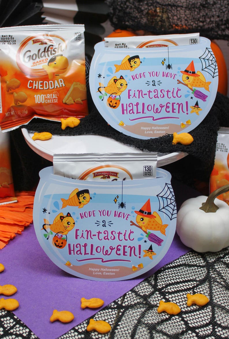 May include: A blue and white Halloween-themed goldfish bowl card with a goldfish wearing a witch hat and holding a broom. The card says "Hope you have a fin-tastic Halloween!" and "Happy Halloween! Love, Easton".