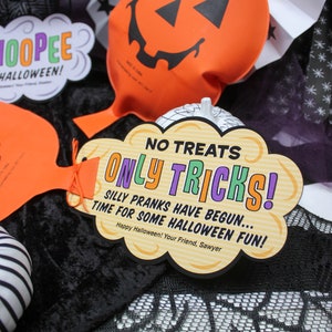 May include: A Halloween trick-or-treat sign with the text "No Treats Only Tricks! Silly Pranks Have Begun... Time For Some Halloween Fun! Happy Halloween! Your Friend, Sawyer" in a speech bubble shape with orange, yellow, green, and purple text on a brown background.