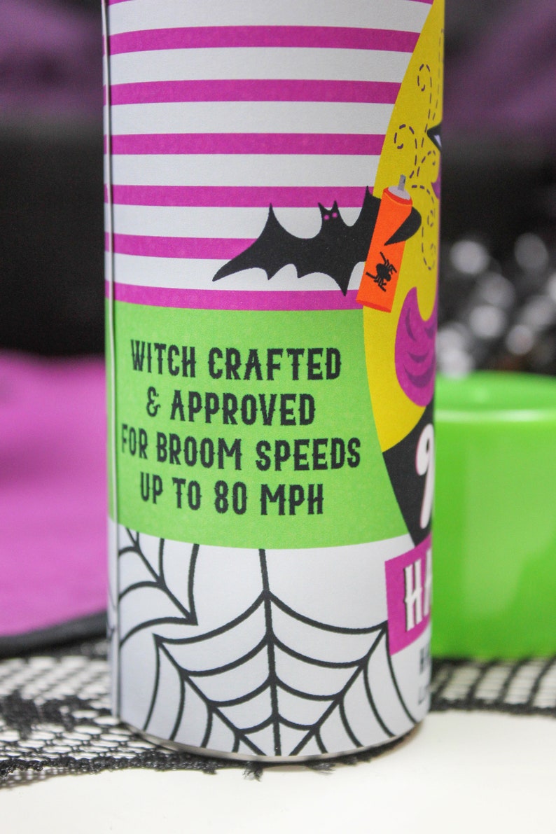 May include: A green and yellow can with a black bat and spider design. The can has white stripes and the text "Witch Crafted & Approved for Broom Speeds Up to 80 MPH".