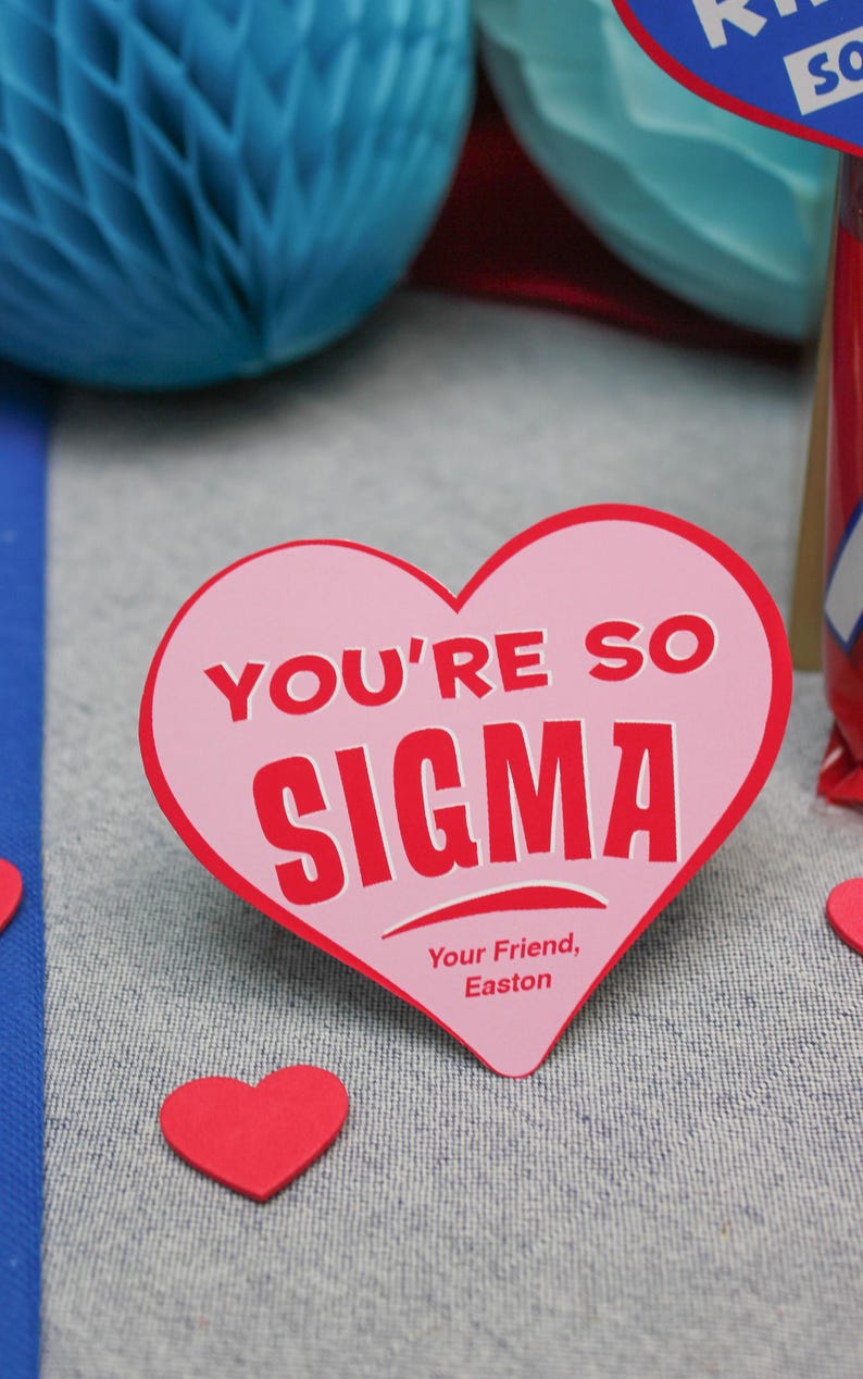 May include: Pink heart-shaped card with the text "You're so Sigma" in red letters. The card also has the text "Your Friend, Easton" in smaller red letters.