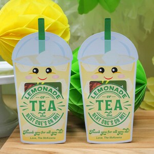 May include: Two yellow and white paper cups with a green straw, a smiling face, and the text "Lemonade or Tea the next one's on me!"  Thank you for all you do! Love, The McKowns.