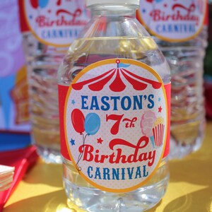 May include: A clear plastic water bottle with a red, white, and blue circus-themed label. The label says "Easton's 7th Birthday Carnival".