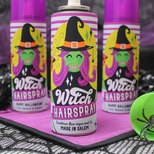 May include: Three purple and white aerosol cans with a witch illustration and the text "Witch Hairspray" on the label. The label also says "Cauldron Boo-tique and Co. Made in Salem".