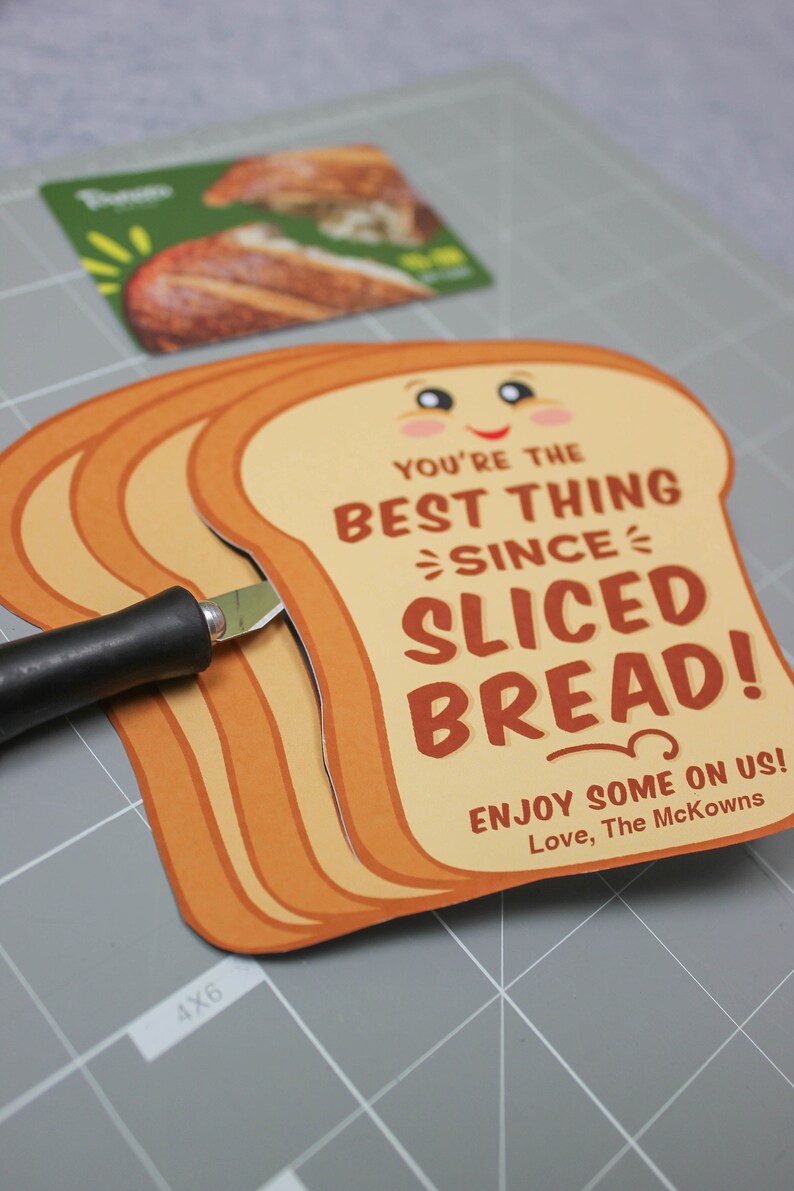 May include: A card shaped like a slice of bread with the text "You're the best thing since sliced bread! Enjoy some on us! Love, The McKowns".