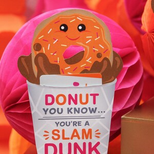 May include: A pink and orange donut-themed card with the text "Donut you know... you're a slam dunk teacher! Love, Sawyer".