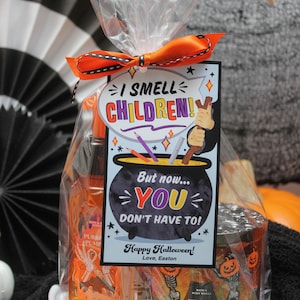 May include: A Halloween gift bag with a tag that reads "I smell children! But now... you don't have to! Happy Halloween! Love, Easton". The bag contains a pumpkin-scented hand sanitizer and a pumpkin carving candle.