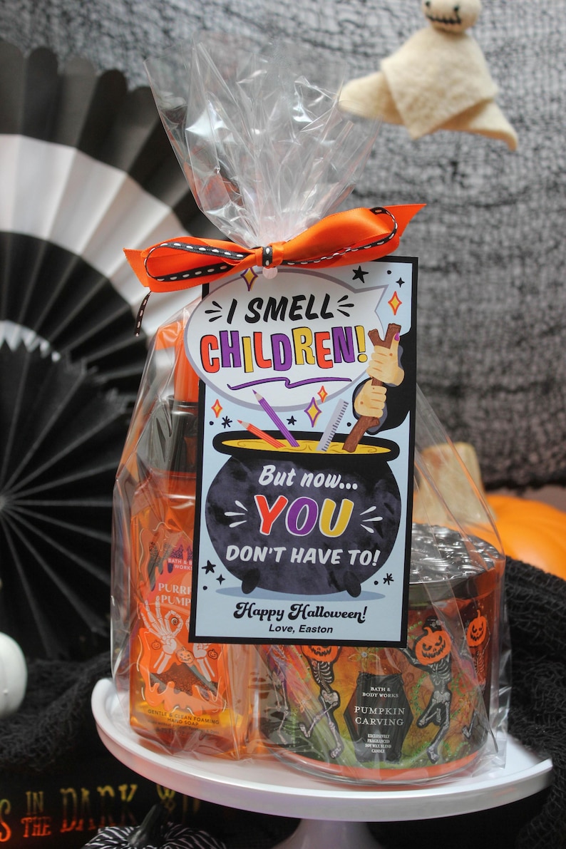 May include: A Halloween gift bag with a tag that reads "I smell children! But now... you don't have to! Happy Halloween! Love, Easton". The bag contains a pumpkin-scented hand sanitizer and a pumpkin carving candle.