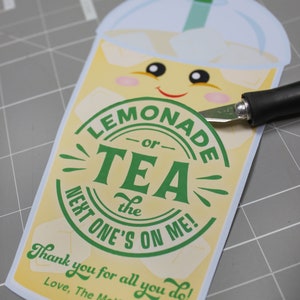 May include: A yellow and green card with a cartoon lemonade cup and the text "LEMONADE -or- TEA the NEXT ONE'S ON ME! Thank you for all you do! Love, The McKowns"