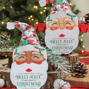May include: Two printable Santa Claus gift tags with a holly jolly Christmas message. The tags are decorated with a red and white candy cane and a green holly sprig. The tags are perfect for adding a festive touch to your holiday gifts.
