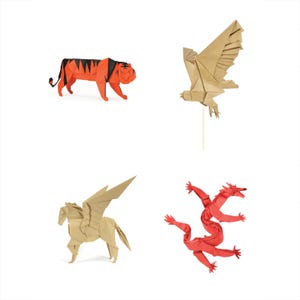 May include: Four origami animal figures: a red and black tiger, a tan eagle, a tan pegasus, and a red three-headed dragon. Each figure is folded from paper and set against a white background.