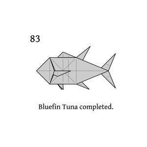 May include: Step 83 of an origami tutorial showing a completed bluefin tuna, a grey paper fish with a folded tail and fins.