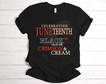 May include: Black t-shirt with the words "Celebrating Juneteenth" in red and cream lettering. The shirt also features the words "Black mixed with Crimson & Cream" with a fist graphic.