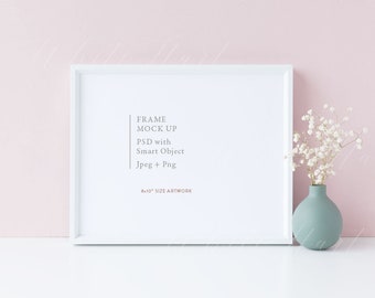May include: White frame mockup with a white background. The frame is 8x10 inches and has a white mat. The text "FRAME MOCK UP PSD with Smart Object Jpeg + Png 8x10" SIZE ARTWORK is printed on the mat. A vase with white flowers sits on a white surface.