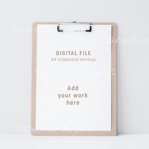 May include: A brown clipboard mockup with a white sheet of paper. The paper has the text "DIGITAL FILE" and "A4 clipboard mockup" in brown text. The paper also has the text "Add your work here" in brown text.