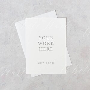 May include: A white card with the text "Your work here" and "5x7" card printed on it. The card is sitting on a light gray surface.