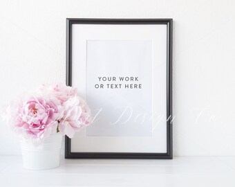 May include: A black picture frame with a white mat and a white background. The frame is sitting on a white surface. The text "Your work or text here" is printed in black on the white background.