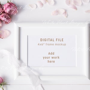 May include: White frame mockup with a 4x6 inch frame size. The frame is on a white surface with pink flowers and petals around it. The text inside the frame says "DIGITAL FILE 4x6" frame mockup Add your work here".