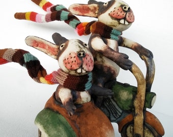 Ceramic Rabbits with hand knitted striped scarves riding a sidecar motorcycle