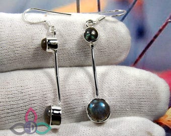 May include: Silver dangle earrings with two round labradorite gemstones. The top gemstone is smaller than the bottom gemstone.