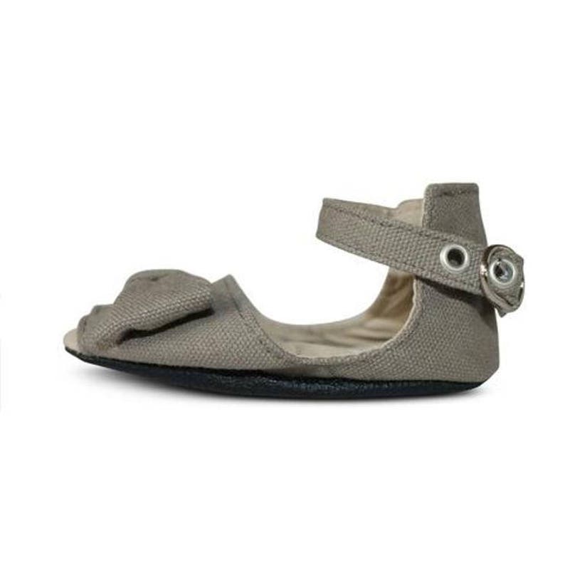 May include: A gray canvas sandal with a peep toe and a bow detail. The sandal has an ankle strap with a metal buckle and eyelets. The sole is black. This footwear is suitable for babies and toddlers.