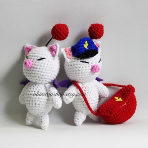 May include: Two white crocheted plushie toys with pink noses and purple wings. One toy is wearing a blue hat with a yellow star. The other toy is carrying a red crocheted bag with a yellow star.